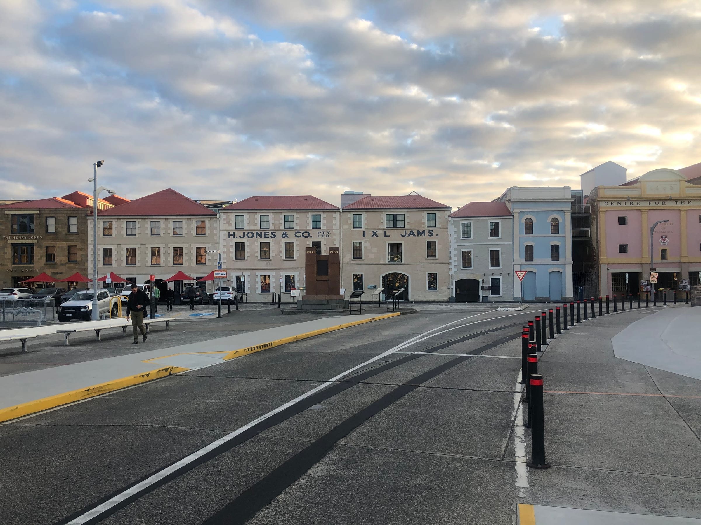 A row of old Georgian sandstone warehouses lining an empty street.